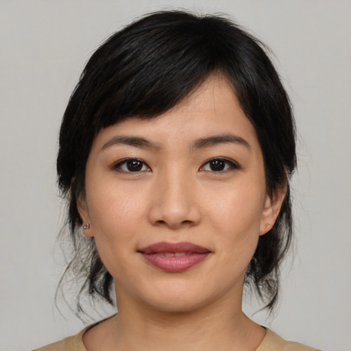 Joyful asian young-adult female with medium  black hair and brown eyes