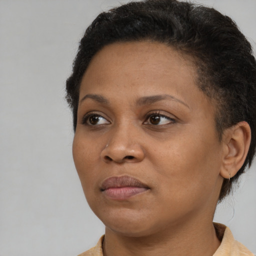 Joyful black young-adult female with short  brown hair and brown eyes