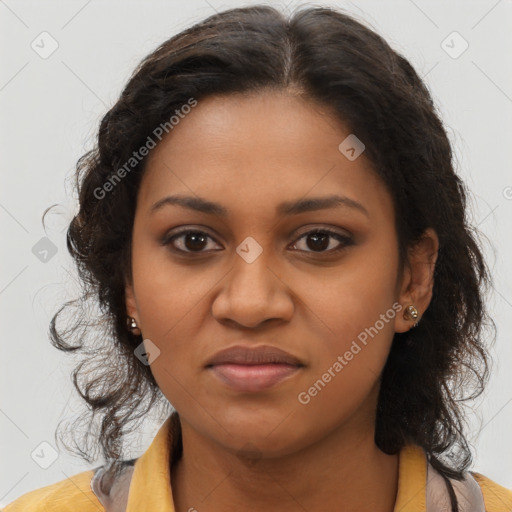 Joyful black young-adult female with long  brown hair and brown eyes