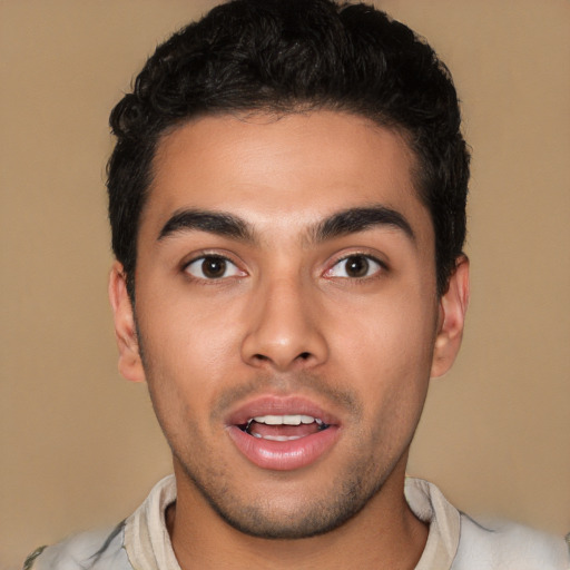 Joyful white young-adult male with short  black hair and brown eyes