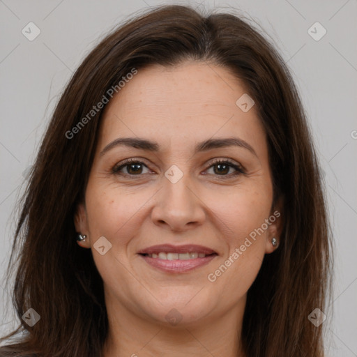 Joyful white adult female with long  brown hair and brown eyes