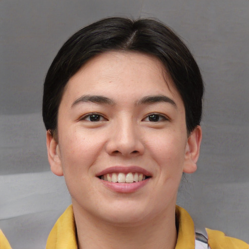 Joyful asian young-adult female with short  brown hair and brown eyes