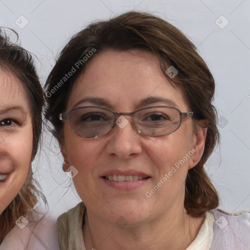 Joyful white adult female with medium  brown hair and blue eyes