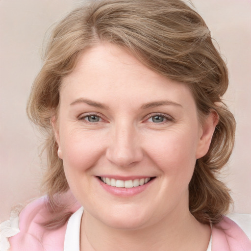 Joyful white young-adult female with medium  brown hair and blue eyes