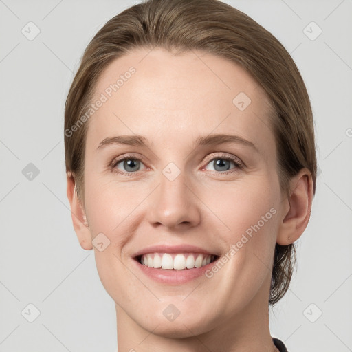 Joyful white young-adult female with long  brown hair and grey eyes