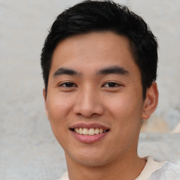 Joyful asian young-adult male with short  black hair and brown eyes