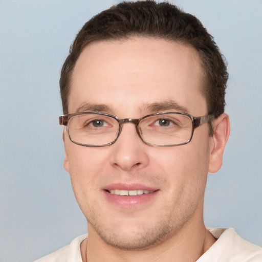 Joyful white young-adult male with short  brown hair and brown eyes