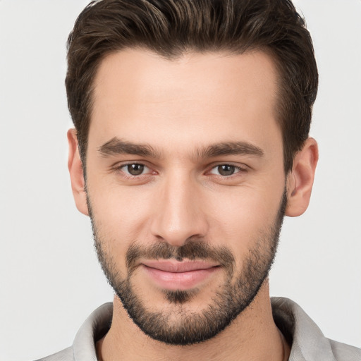 Joyful white young-adult male with short  brown hair and brown eyes