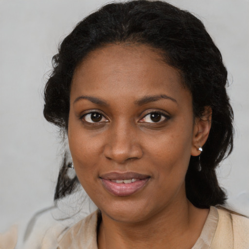 Joyful black young-adult female with medium  black hair and brown eyes
