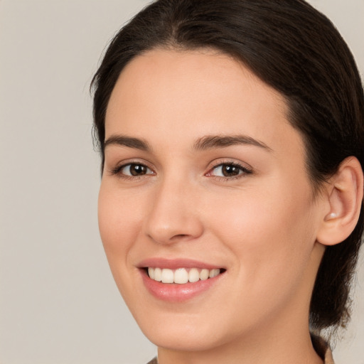 Joyful white young-adult female with medium  brown hair and brown eyes