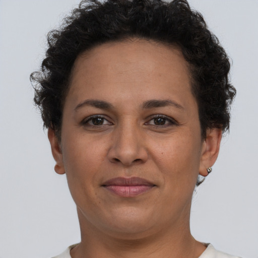 Joyful latino adult female with short  brown hair and brown eyes