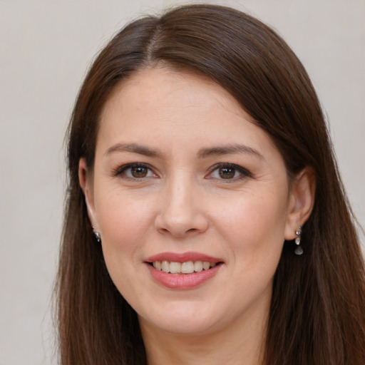 Joyful white young-adult female with long  brown hair and brown eyes