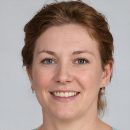 Joyful white adult female with medium  brown hair and grey eyes