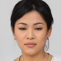 Joyful asian young-adult female with medium  black hair and brown eyes