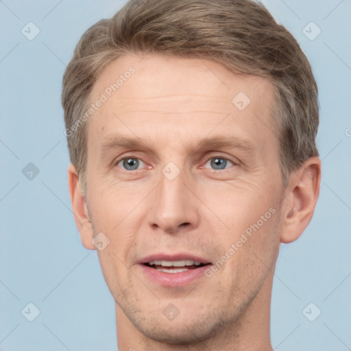 Joyful white adult male with short  brown hair and grey eyes