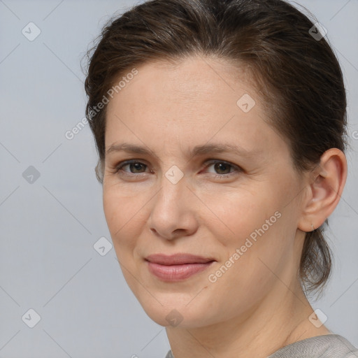 Joyful white adult female with medium  brown hair and brown eyes