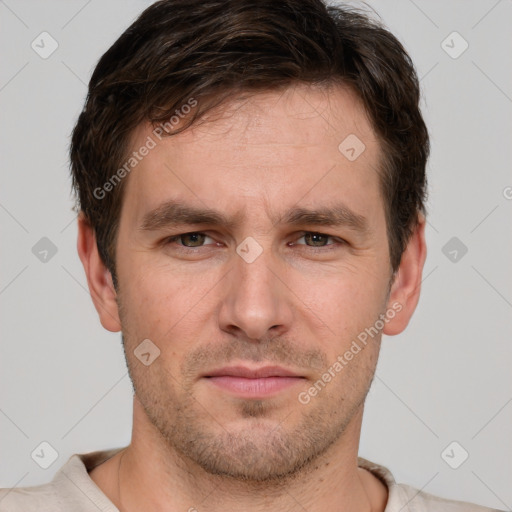 Joyful white adult male with short  brown hair and grey eyes