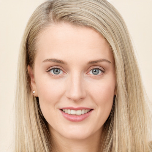 Joyful white young-adult female with long  brown hair and blue eyes