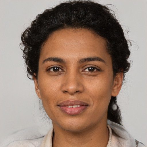 Joyful latino young-adult female with short  brown hair and brown eyes