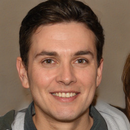 Joyful white adult male with short  brown hair and brown eyes