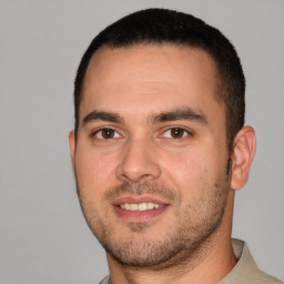 Joyful white young-adult male with short  brown hair and brown eyes