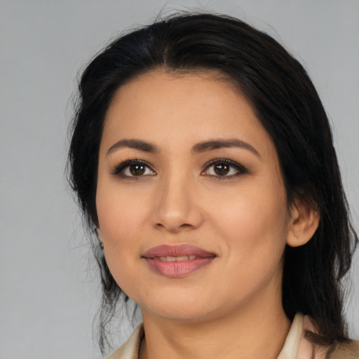 Joyful latino young-adult female with medium  black hair and brown eyes