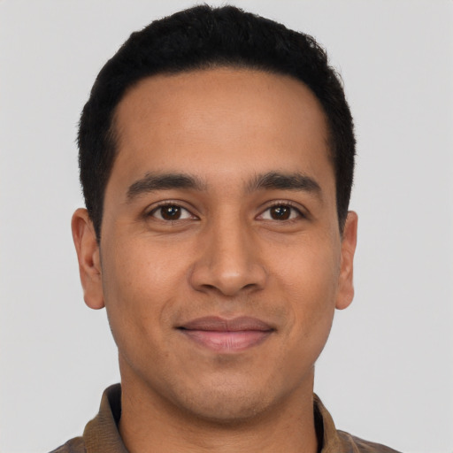 Joyful latino young-adult male with short  black hair and brown eyes