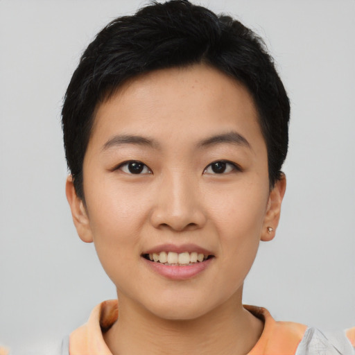 Joyful asian young-adult female with short  black hair and brown eyes