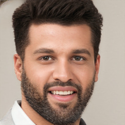 Joyful white young-adult male with short  black hair and brown eyes