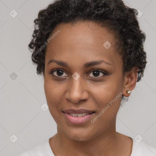 Joyful black young-adult female with short  brown hair and brown eyes