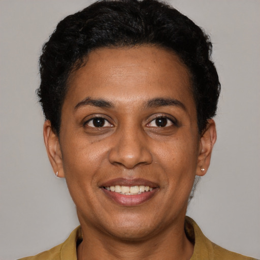 Joyful black young-adult female with short  black hair and brown eyes