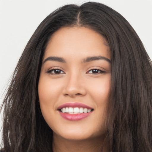 Joyful latino young-adult female with long  black hair and brown eyes