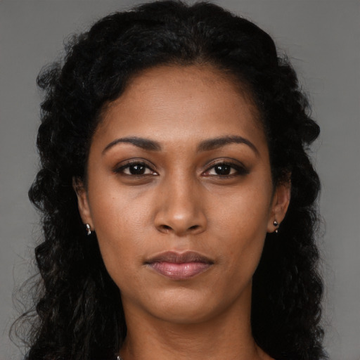 Neutral black young-adult female with long  brown hair and brown eyes