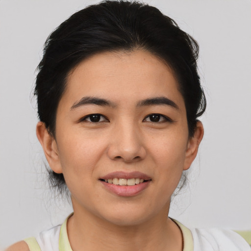 Joyful asian young-adult female with short  black hair and brown eyes