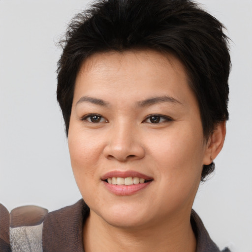 Joyful asian young-adult female with short  brown hair and brown eyes