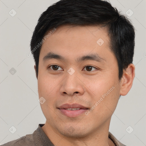 Joyful white young-adult male with short  black hair and brown eyes