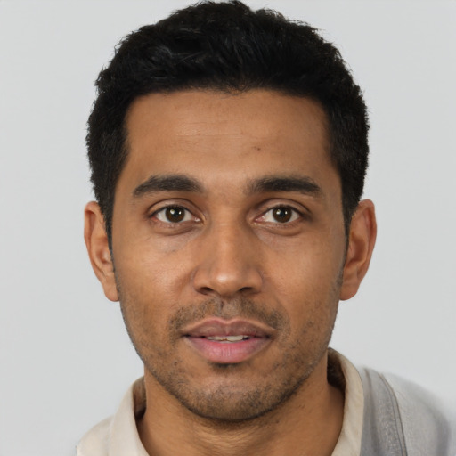 Joyful latino young-adult male with short  black hair and brown eyes