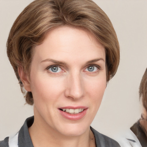 Joyful white young-adult female with medium  brown hair and blue eyes