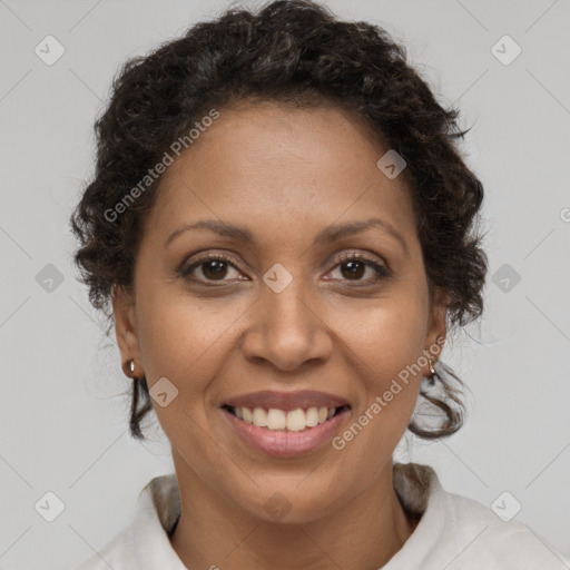 Joyful black adult female with short  brown hair and brown eyes