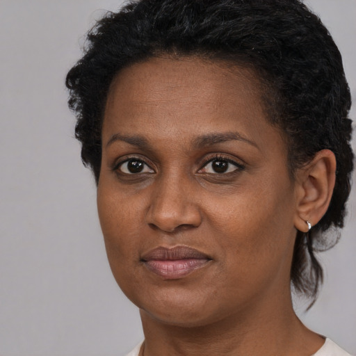 Joyful black adult female with short  brown hair and brown eyes