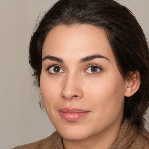 Joyful white young-adult female with medium  brown hair and brown eyes