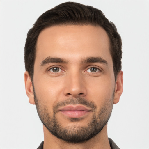 Joyful white young-adult male with short  brown hair and brown eyes