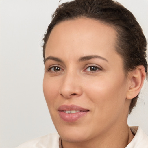 Joyful white adult female with medium  brown hair and brown eyes