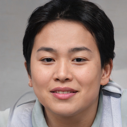 Joyful asian young-adult female with short  brown hair and brown eyes