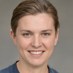 Joyful white young-adult female with short  brown hair and grey eyes