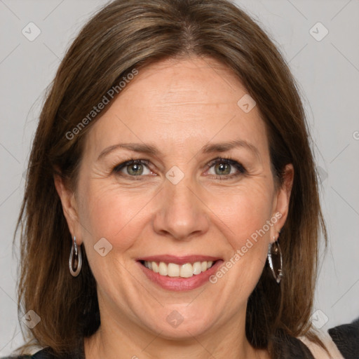 Joyful white adult female with medium  brown hair and grey eyes