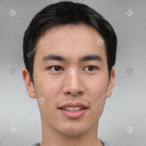 Joyful asian young-adult male with short  brown hair and brown eyes