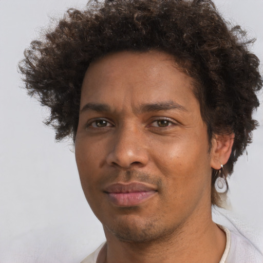 Joyful black adult male with short  brown hair and brown eyes