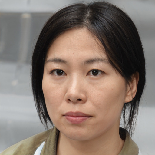 Neutral asian young-adult female with medium  brown hair and brown eyes