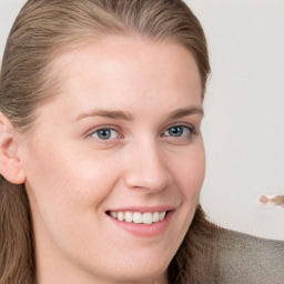 Joyful white young-adult female with long  brown hair and blue eyes